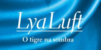 Recorte da capa do livro. Fundo com um tecido azul brilhante com algumas dobras, no primeiro plano o nome da autora Lya Luft, abaixo o titulo "O tigre na sombra".