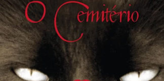 Recorte da capa do livro "O Cemitério". Foco nos olhos de um gato cinza com um tom levemente demoníaco. O topo, escrito em vermelho, "O Cemitério".